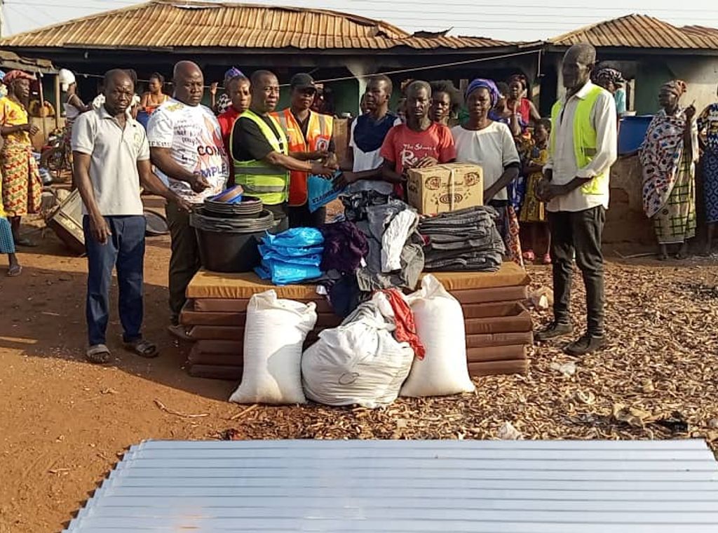 Geoffrey Kini donates relief items to support disabled fire victim